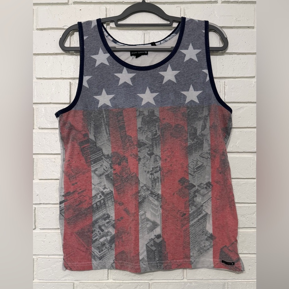 Ocean Current American flag tank top featuring a cityscape graphic overlay.